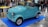 A happy customer standing next to their new microcar.