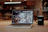 a laptop with a coffee cup