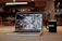 a laptop with a coffee cup