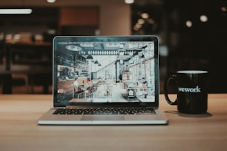 a laptop and a mug of coffee