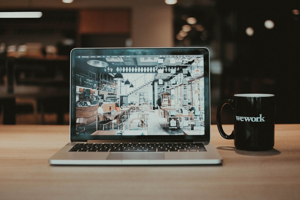 a laptop and a mug of coffee