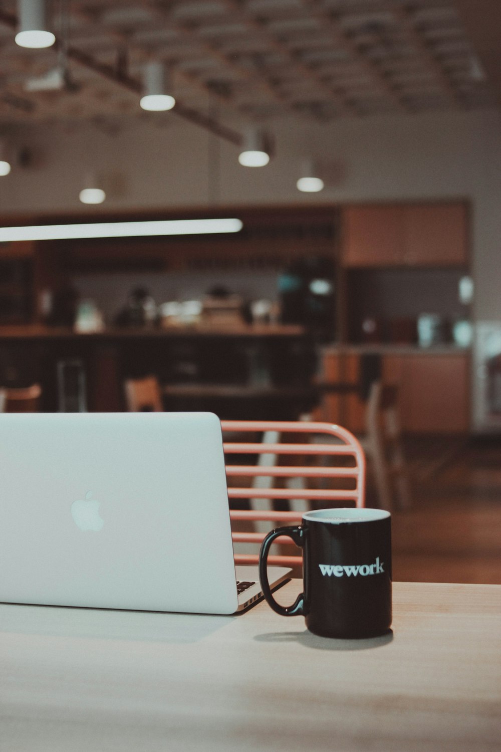 a coffee mug and a laptop on a table