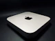 A sleek, modern electro-shock device resting on a wooden table next to keys and a phone.