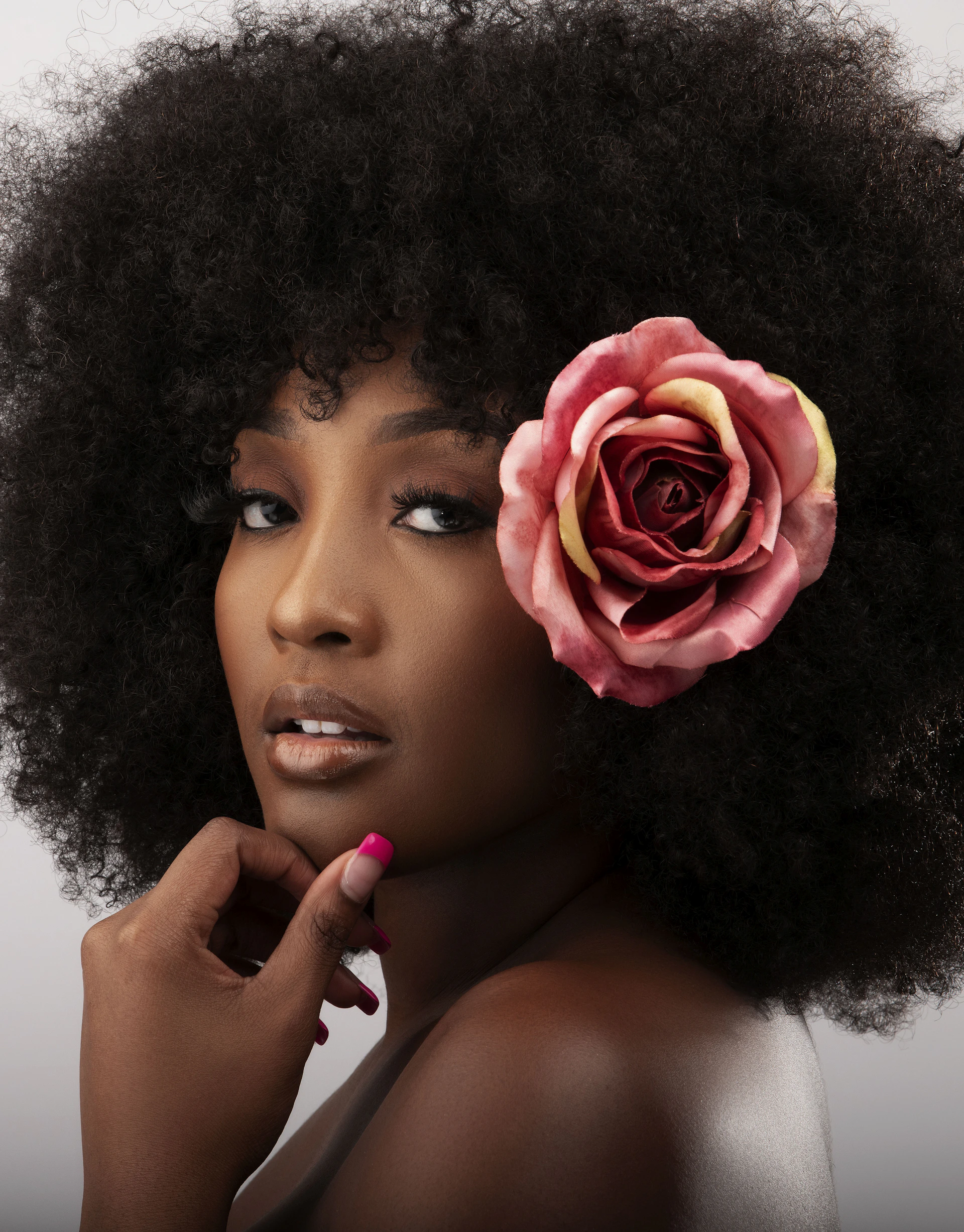 a person with a rose in the hair