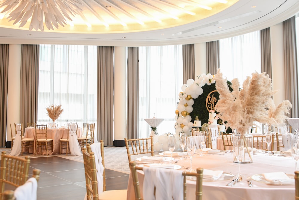 a dining room with tables set for a wedding