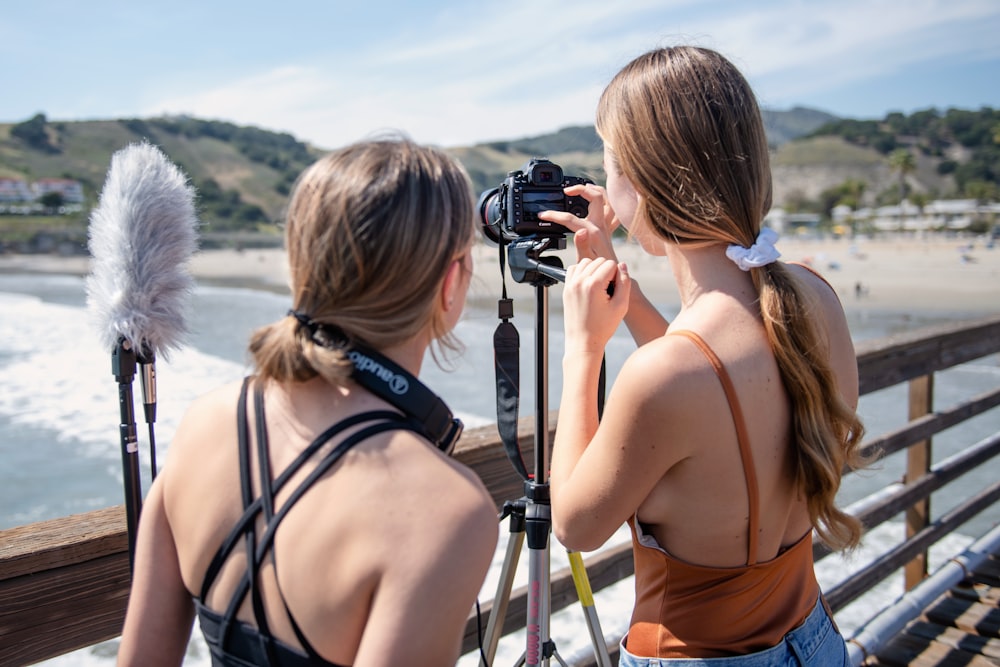 a couple of women taking pictures