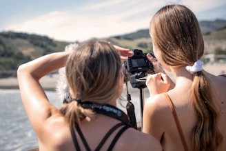 a woman taking a picture of another woman with a camera
