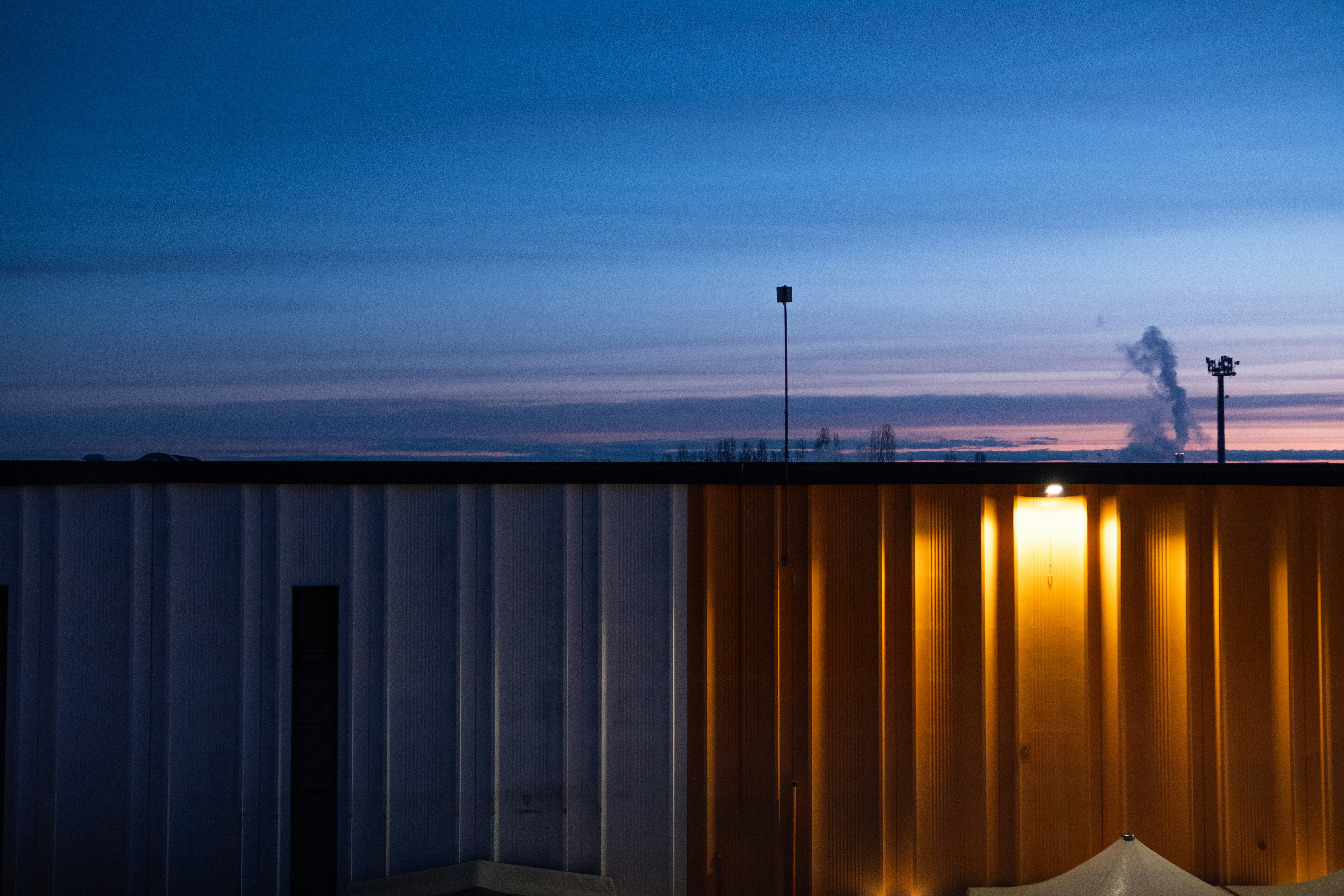 a sunset behind a fence