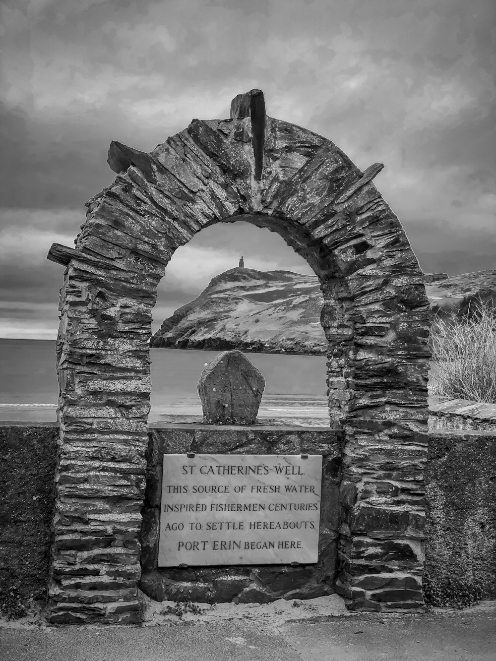 a stone archway with a sign