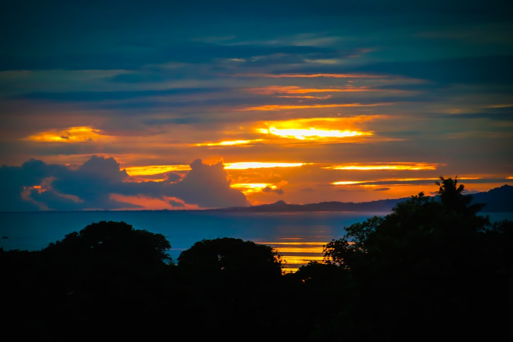 a sunset over trees