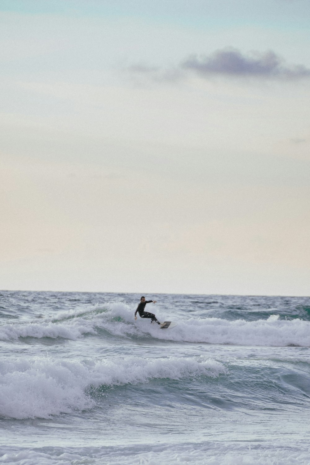 a person surfing on the waves