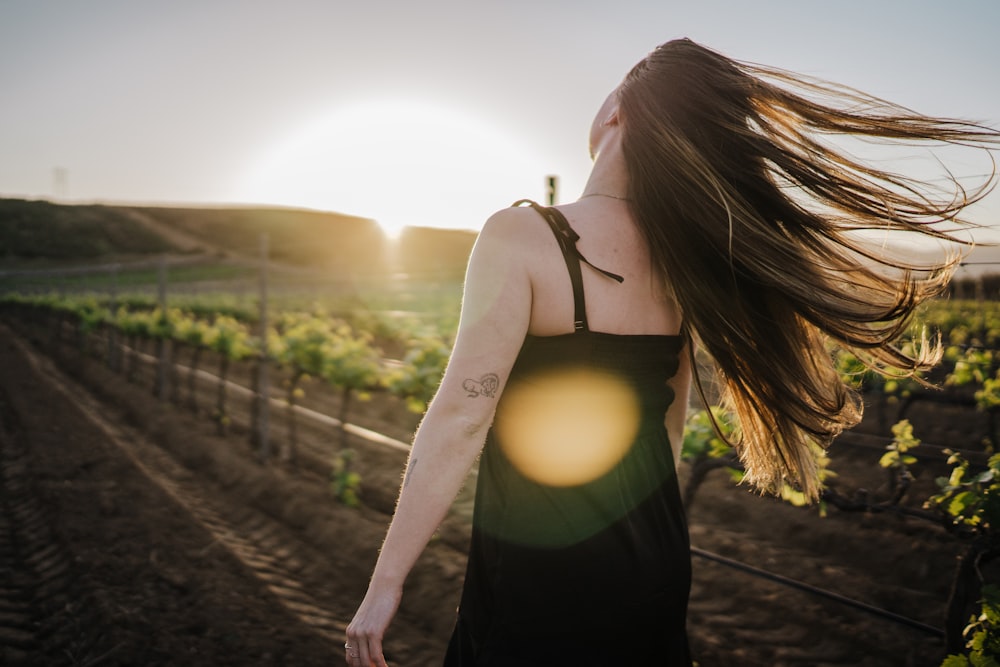 a woman walking on a dirt road