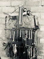 A set of sturdy workholding vices and clamps arranged neatly.