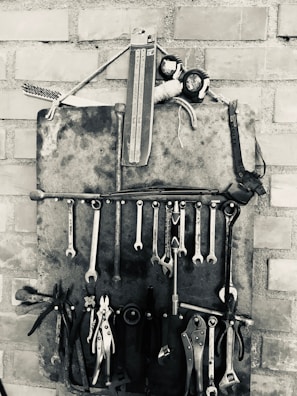 A neatly organized toolbox with vintage plumbing tools and fittings.