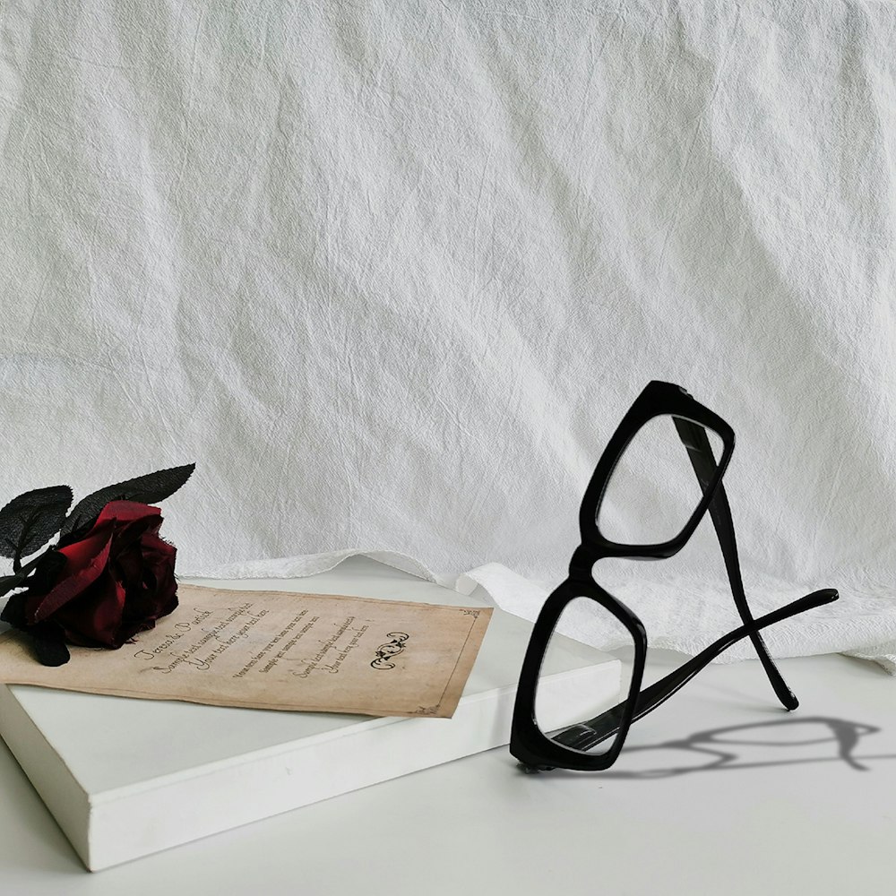 a pair of glasses and a book on a table
