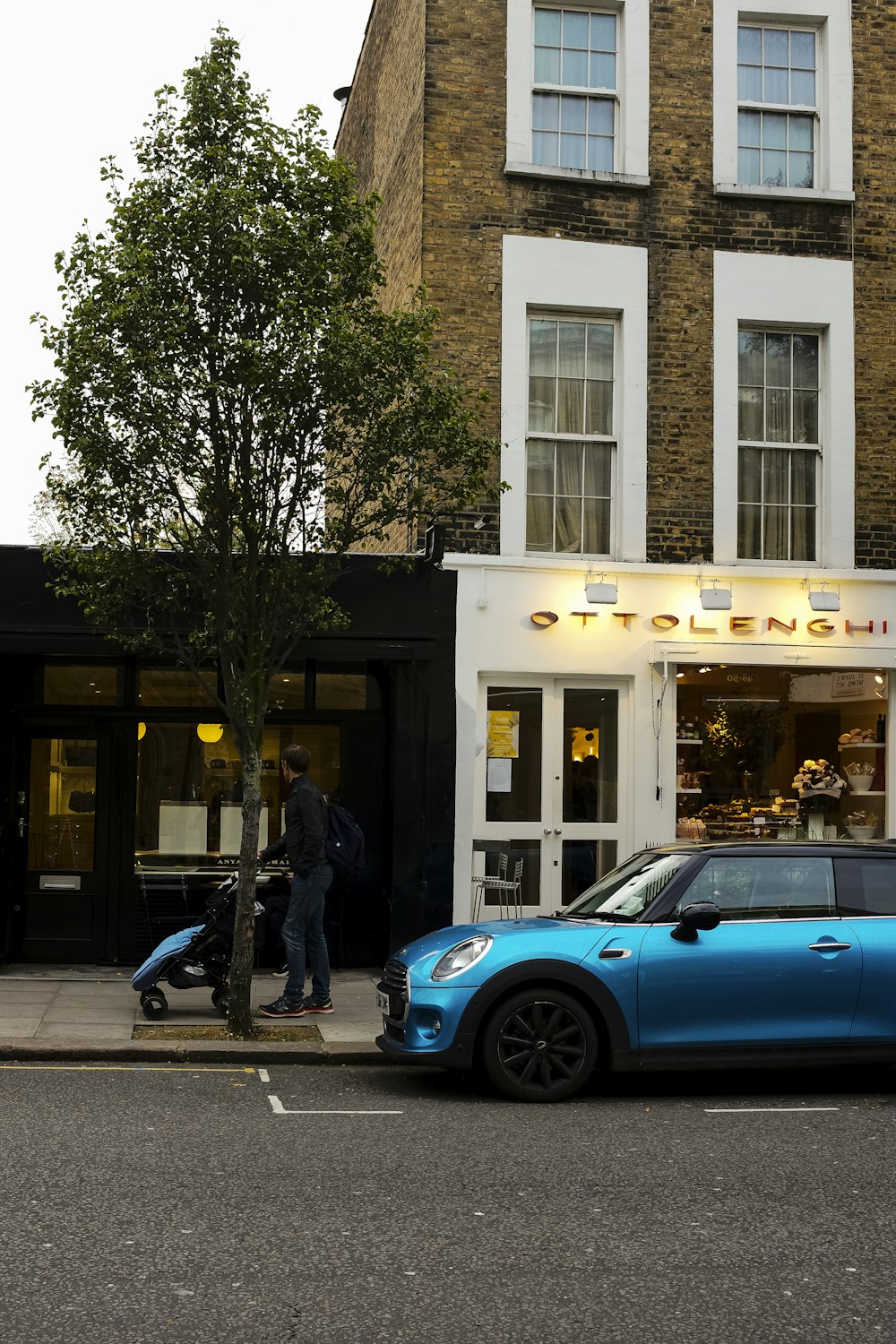 a blue car parked in front of a building