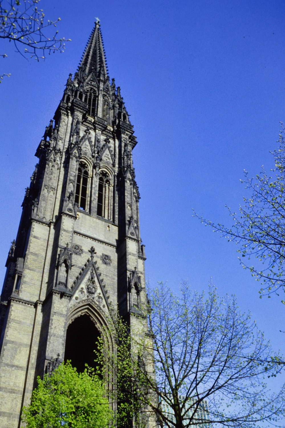 a tall stone building with Harkness Tower in the background