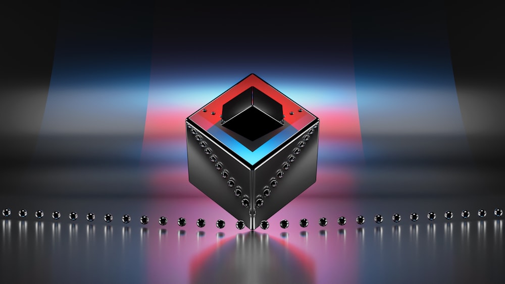 a red and black cube with a black and white design on it