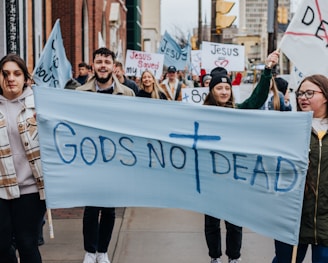 a group of people marching with a banner