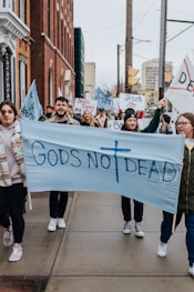 a group of people marching with a banner