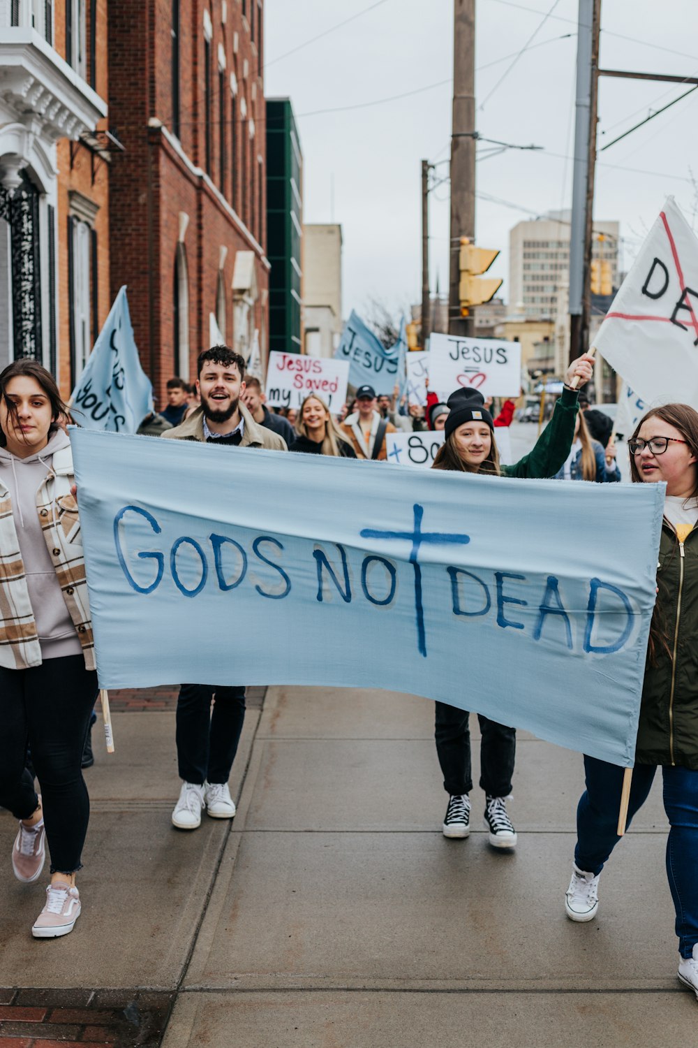 a group of people marching with a banner