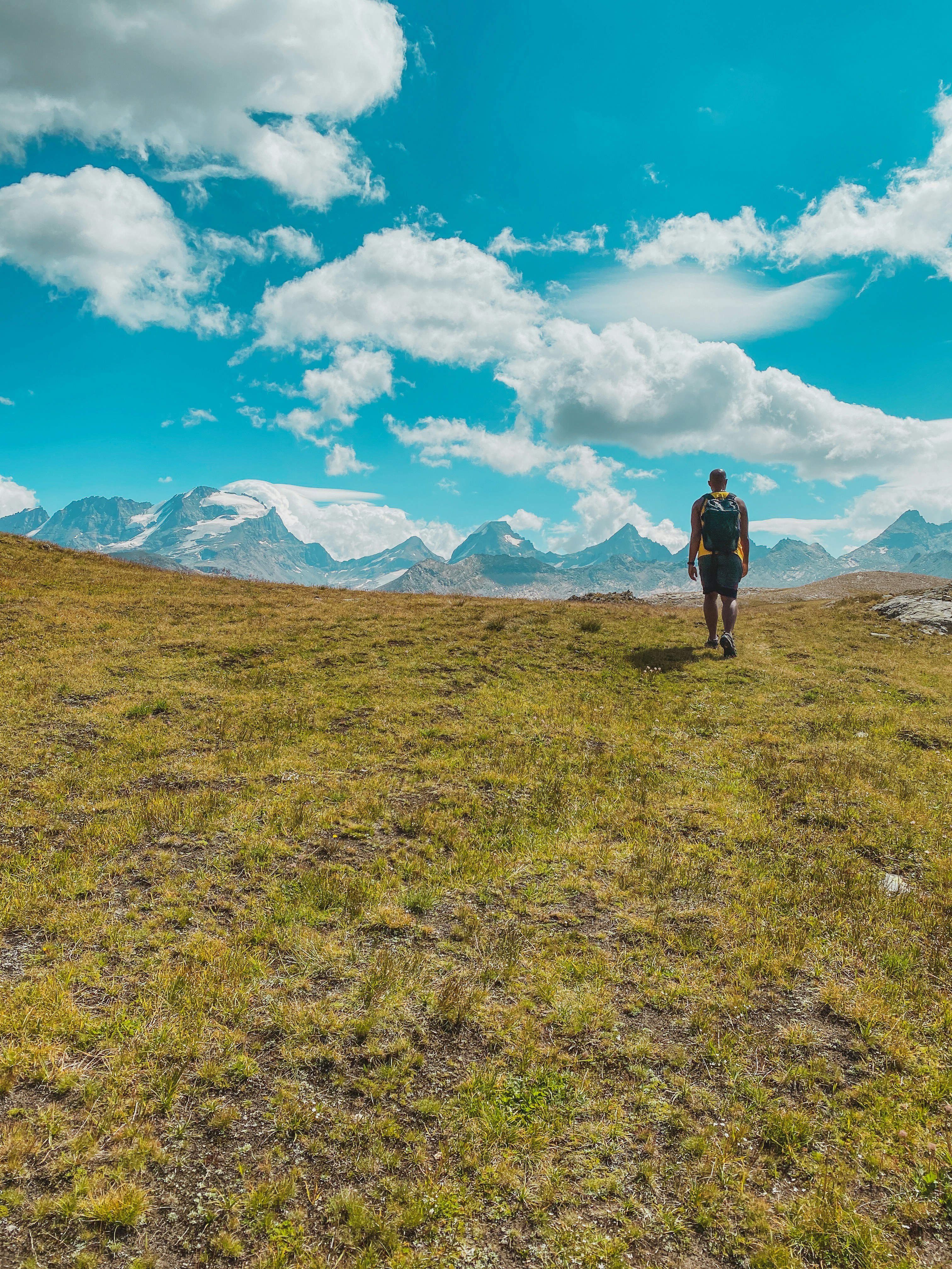 A man standing in a field photo – Free Blue Image on Unsplash