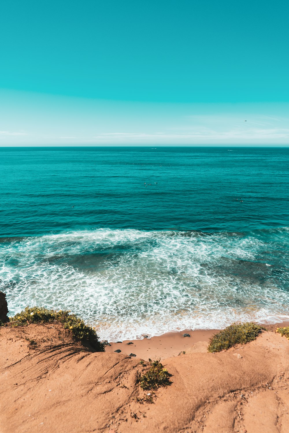 a sandy beach with waves crashing on it