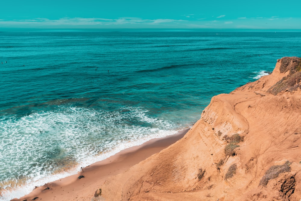 a rocky beach with waves crashing on it