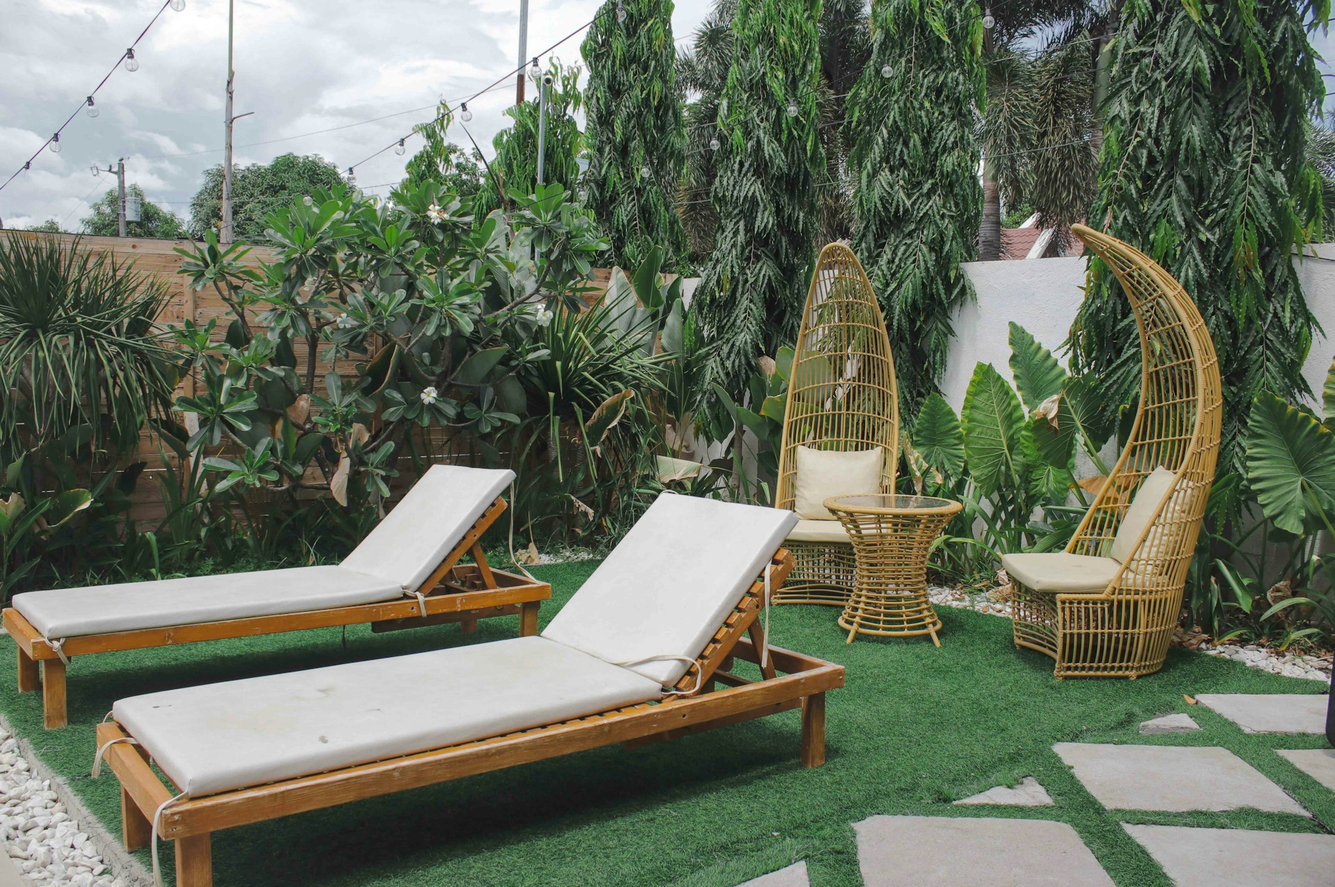 a lounge chair and a hammock in a yard