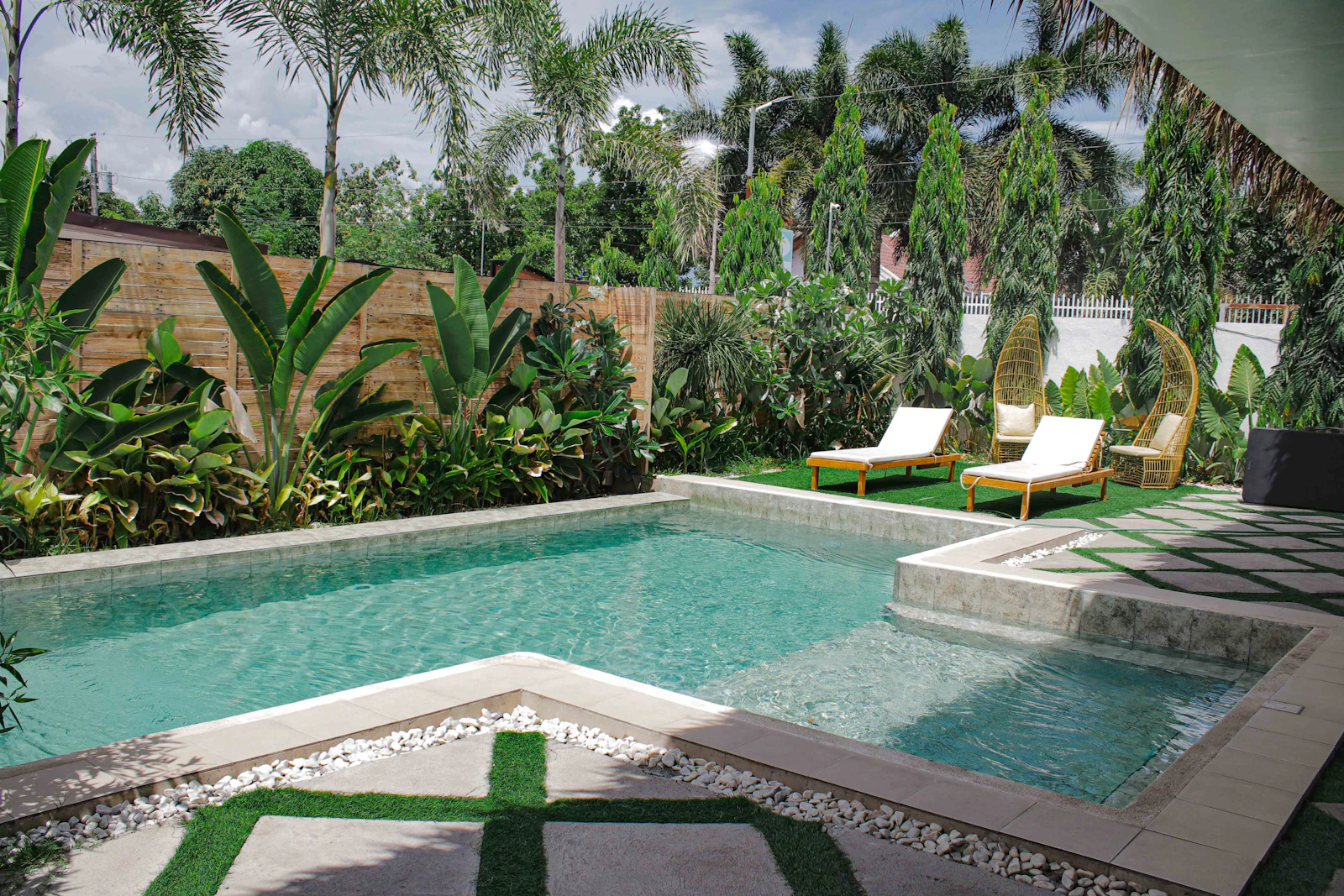 AI concept: resort style pool garden with palms and lounge chairs