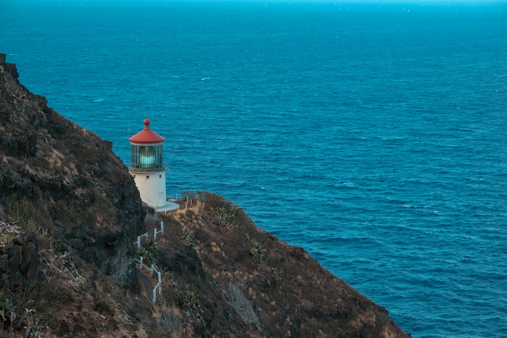 a lighthouse on a cliff above the ocean