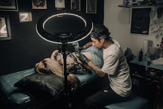 a man with a tattoo on his arm and a woman with a drum