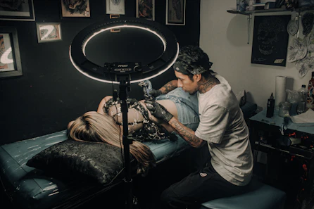 a man with a tattoo on his arm and a woman with a drum