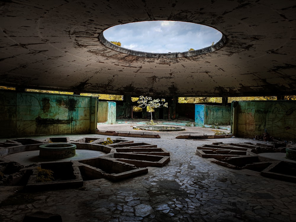 a stone courtyard with a round light