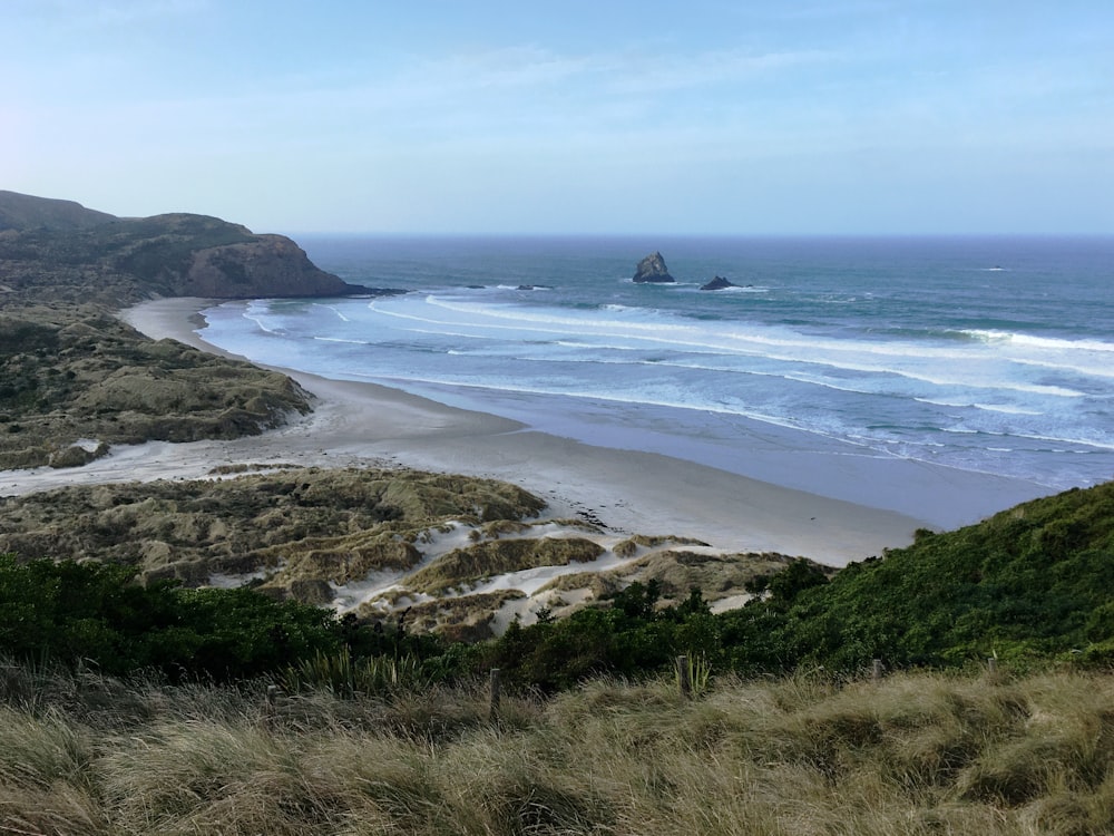 a beach with waves crashing on it with Pacifica State Beach in the background