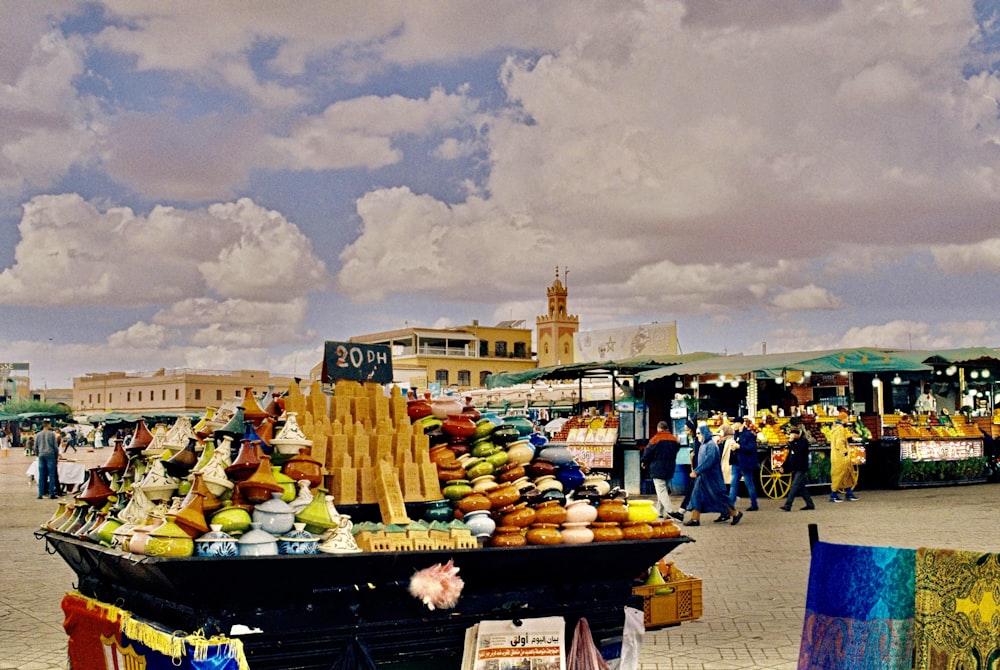 a street market with people and food