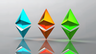 Three three-dimensional geometric shapes resembling Ethereum logos, each in different colors, are aligned horizontally. The shapes have reflections on the glossy surface below them, and the background is a smooth gradient with a subtle gray tone.