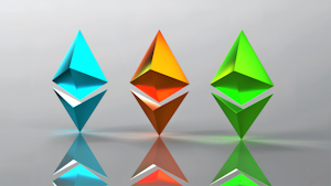 Three three-dimensional geometric shapes resembling Ethereum logos, each in different colors, are aligned horizontally. The shapes have reflections on the glossy surface below them, and the background is a smooth gradient with a subtle gray tone.
