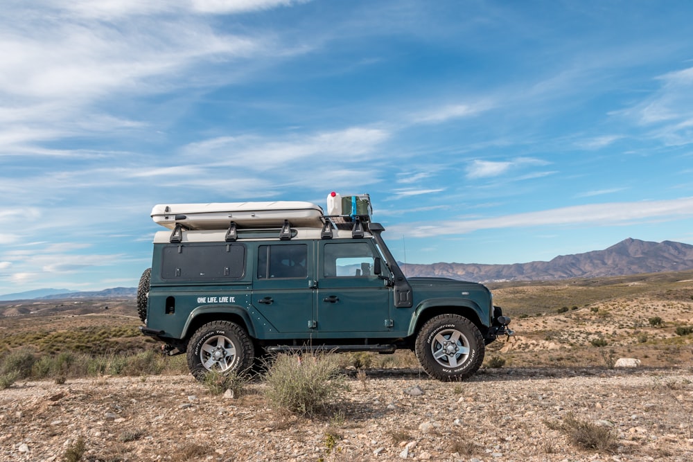a green truck parked in a desert