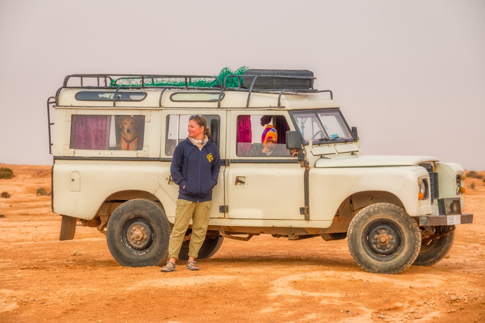 a person standing next to a jeep