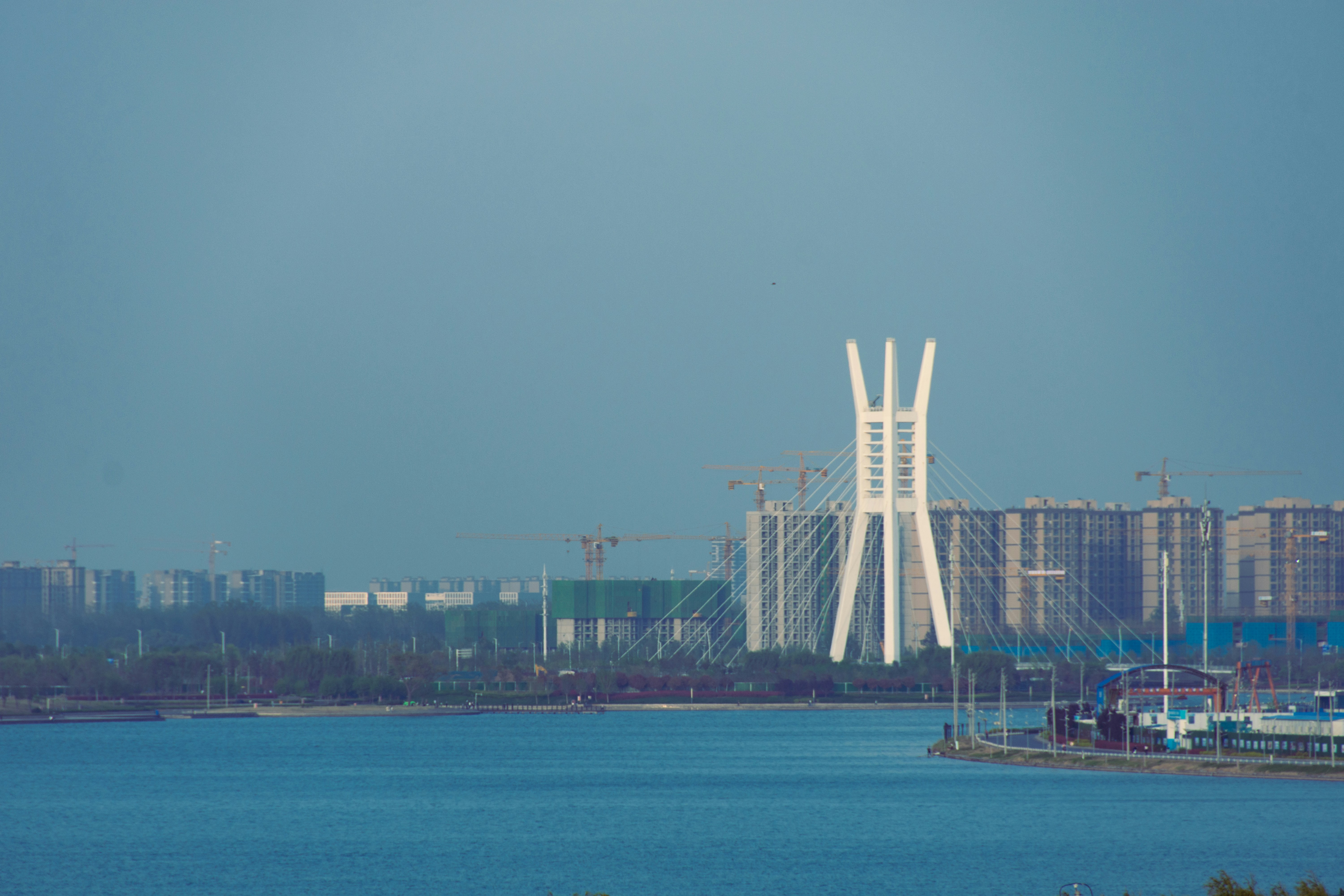 a bridge over water with buildings in the background