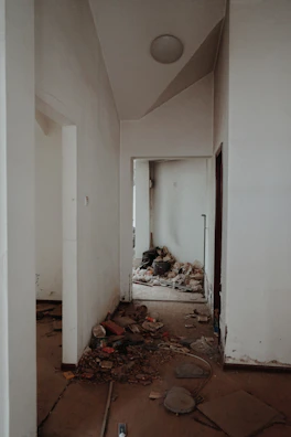 Dim, cluttered crawl space before cleanup and repair.