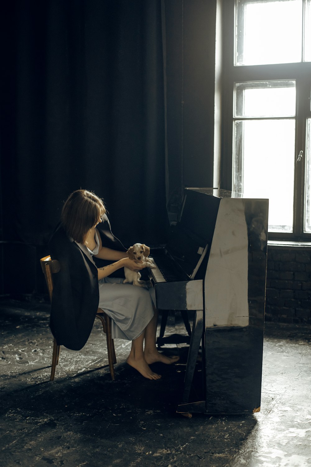 a person sitting in a chair holding a dog