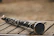 A close-up of a clarinet showing light surface scratches and its polished keys.