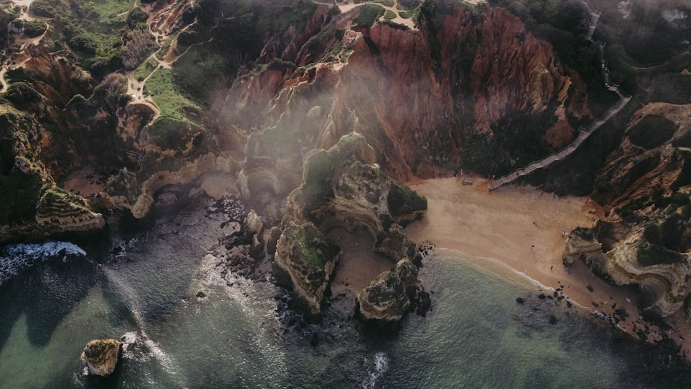 a rocky beach with a body of water