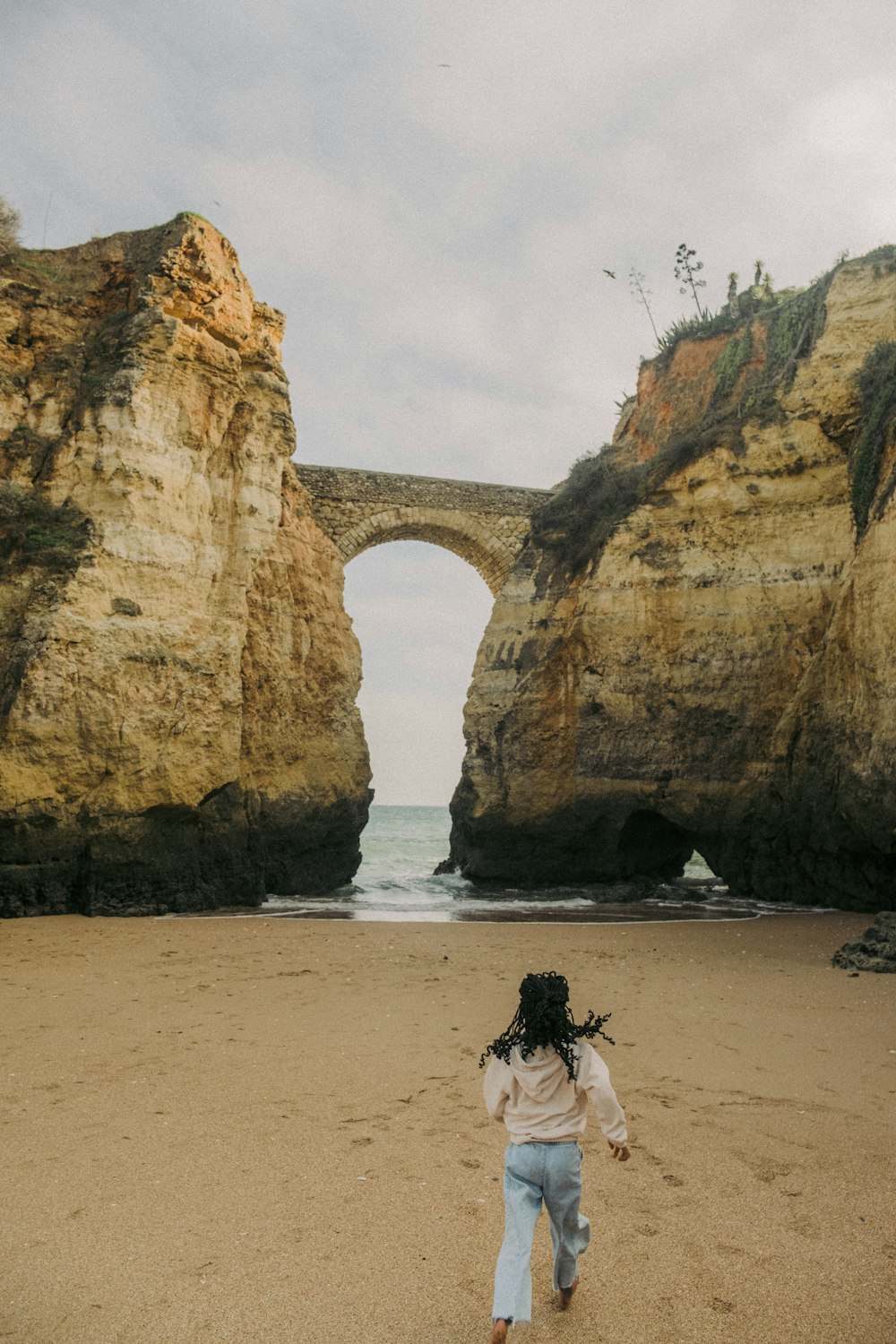 a man walking on a beach