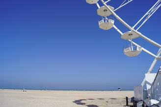 a group of white windmills on a beach