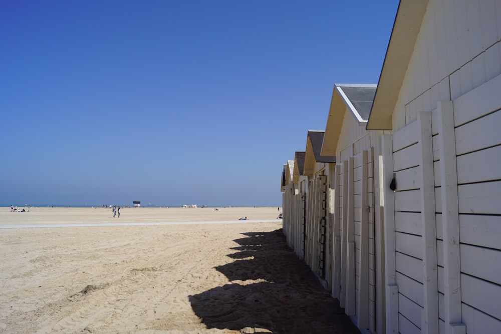 a row of wooden buildings on a beach