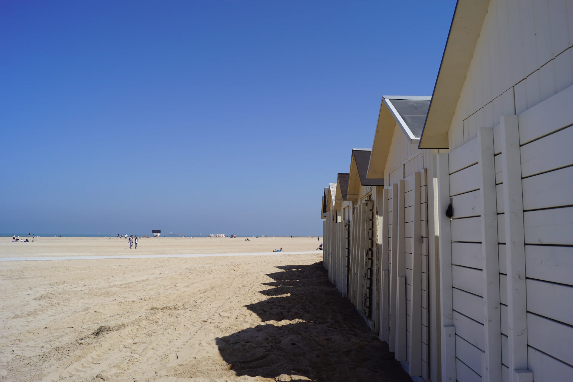 a row of wooden buildings on a beach