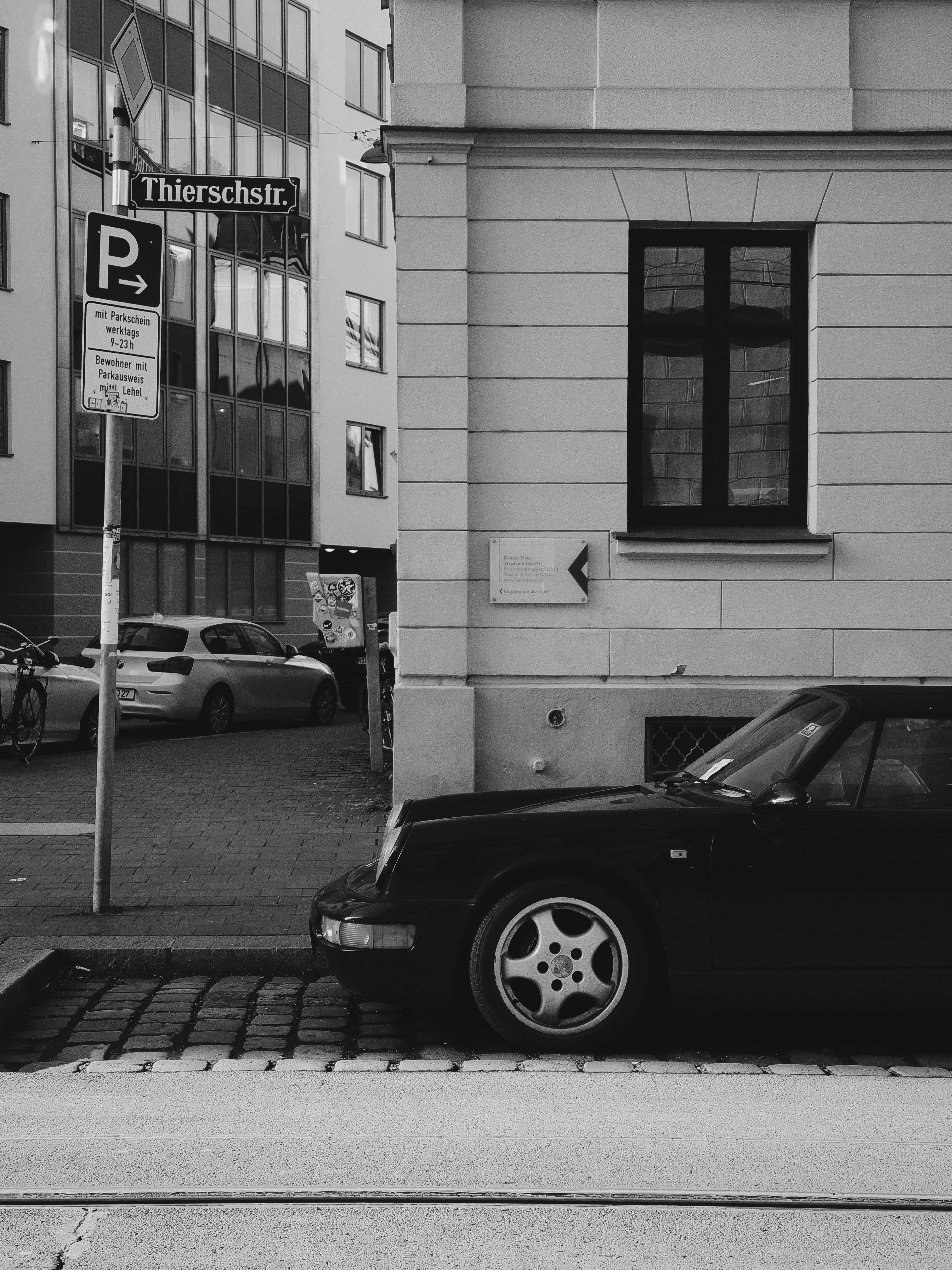 a black car parked on the side of a street
